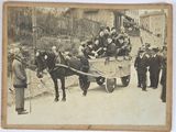 a vintage photo of a group of people riding in a horse drawn carriage