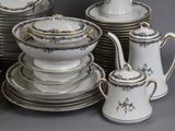 many plates and cups and saucers on the table