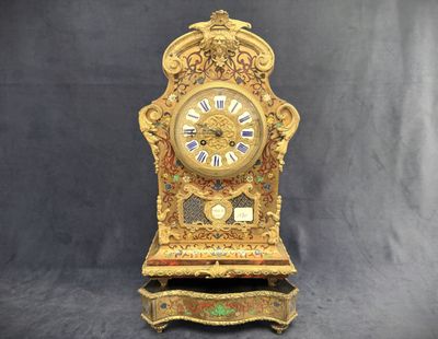 a clock that is sitting on a stand on a black background