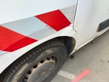 a red and white stripe on the side of a white van