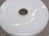 a white sink sitting on a counter top with a hole in it