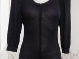 the dress is black and has a zippered neckline