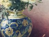 a painting of a vase of flowers and fruit on a table