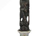 a statue of a man holding a bear on a pedestal