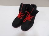 black and red sneakers with red laces on a white surface