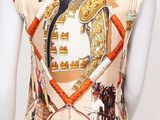 an image of a mannequin wearing a top with a horse and rider pattern