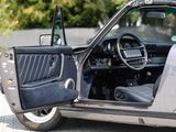 a car with the door open sitting on the side of the road
