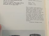 someone is holding a book open to a page with a picture of a silver object