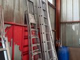 many ladders leaning up against the wall in a building