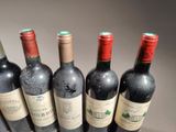 six bottles of wine are lined up in a row on a table