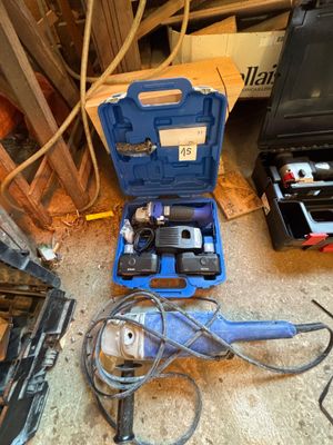 une boîte à outils bleue avec des outils sur le sol
