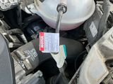a close up of a car engine with a fuel tank
