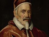 portrait d'un homme vêtu d'une robe rouge, à la barbe blanche et coiffé d'un bonnet rouge