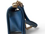 the small blue purse has a gold chain around it