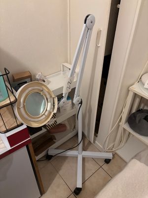a lamp that is sitting on a stand in the corner of a room