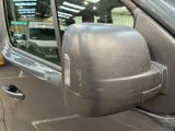 a side view mirror of a car that is parked in a parking lot