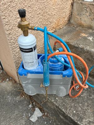 an image of a water filtrator and a hose on the ground