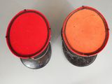 two red and orange buckets sitting on top of a white table