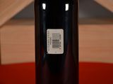 a bottle of wine sitting on a table with a label on it