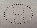 an image of a close up of a metal plate with holes in it