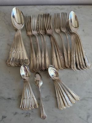 beaucoup de cuillères en argent et de cuillères à soupe sur une table
