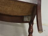 a wooden chair with a brown seat and a brown cushion on it