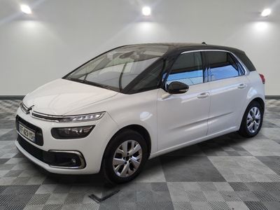 the white citrole is parked on a checkered tile floor