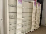 many shelves in a store that have glass shelves on them