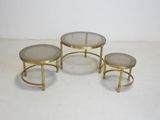 three tables with glass tops and gold metal bases