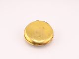 an image of a gold pocket watch on a white surface