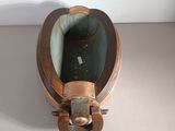 a small wooden box with a metal handle on a table