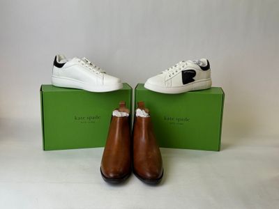 pair of brown and white shoes sitting on top of a green box
