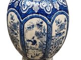 a blue and white vase with a picture on it