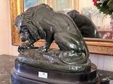 a statue of a lion sitting on a marble table