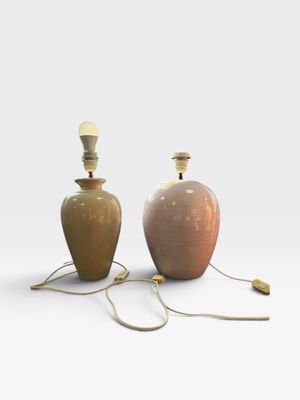 pair of ceramic lamps with brass fittings on a white background