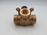 a close up of a brass ball valve on a white surface