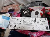 a pile of items on a bed that includes a book, a pair of scissors, a pair of scissors, a pair of scissors, a pair of