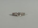 an engagement ring with a diamond set in the middle of it
