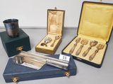 several silverware items are sitting in a case on a table