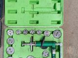 a green case with tools in it on the floor