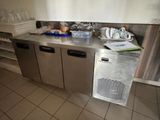 a stainless steel counter top with a dishwasher in it