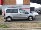 a silver van parked in front of a building
