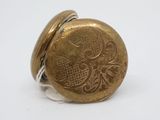 a gold button that has a design on it