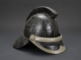 helmet of a roman soldier with a visor on a gray background