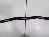 two camera straps that are attached to the back of a white surfboard