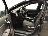 the interior of a car with the door open and the driver ' s seat down