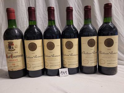 six bottles of red wine are lined up on a table