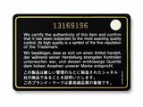 black and gold plaque on a white wall with a black background