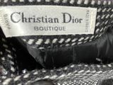 a close up of a black and white coat with a label on it