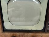 a small television sitting on top of a wooden table